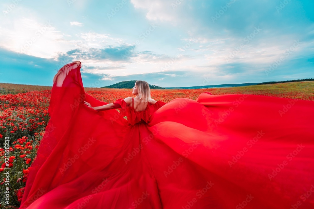 Woman poppy field red dress. Happy woman in a long red dress in a beautiful large poppy field. Blond stands with her back posing on a large field of red poppies Woman poppy field red dress. Happy woman in a long red dress in a beautiful large poppy field. Blond stands with her back posing on a large field of red poppies