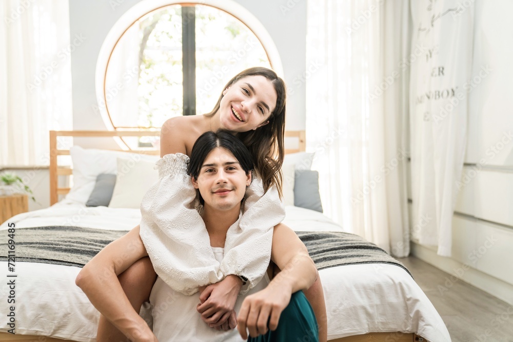 Obraz premium Portrait of a caucasian couple loving at home or hotel room together laughing and having fun. Happiness and joyful expression man and a woman celebrating Valentine's Day.