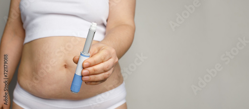 Semaglutide and weight loss concept. Woman showing Semaglutide Injection pen or insulin cartridge pen. photo