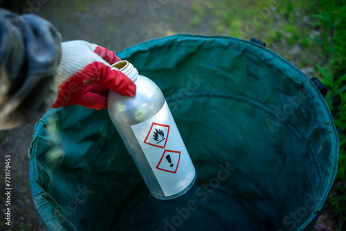 Chemically dangerous substances.A gloved hand holds a bottle of poisonous liquid.Disposal of toxic industrial waste. photo