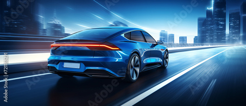 A luxury electric car travels at high speed on the motorway. Rear view of a fast moving car. © trompinex