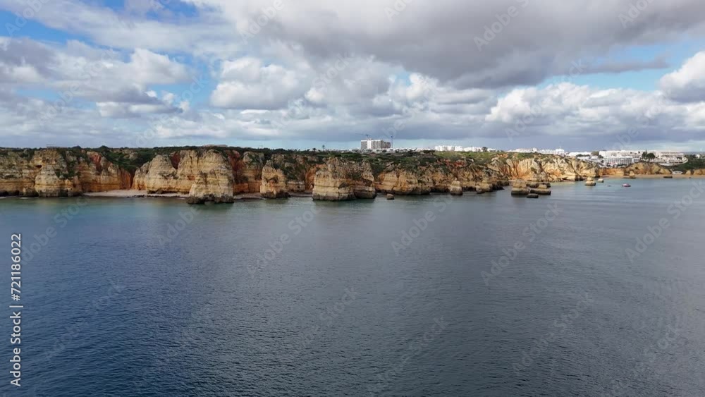 The beautiful Praia do Camilo with its golden sandstone cliffs located in Lagos on the Algarve region of southern Portugal. The beautiful Praia do Camilo with its golden sandstone cliffs located in Lagos on the Algarve region of southern Portugal.