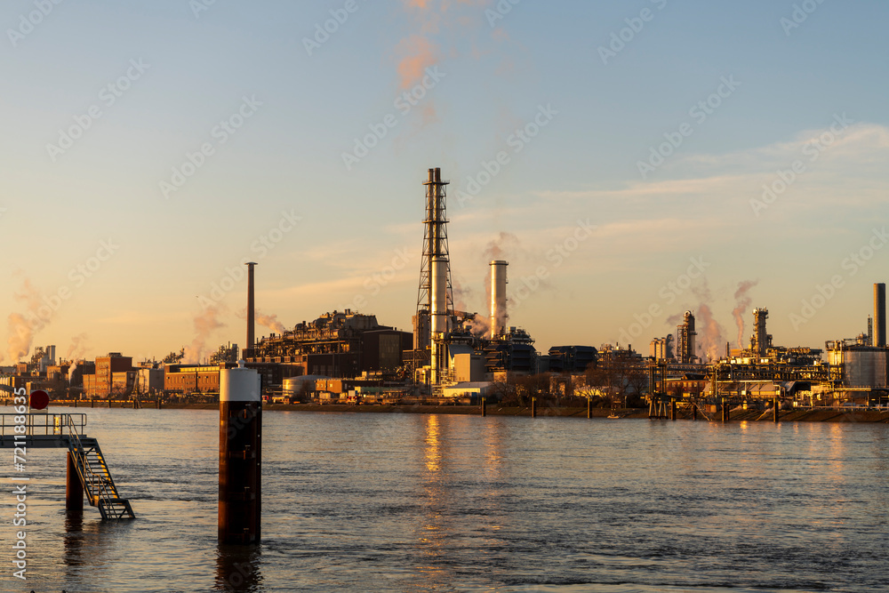 river at sunrise with chemical plant
