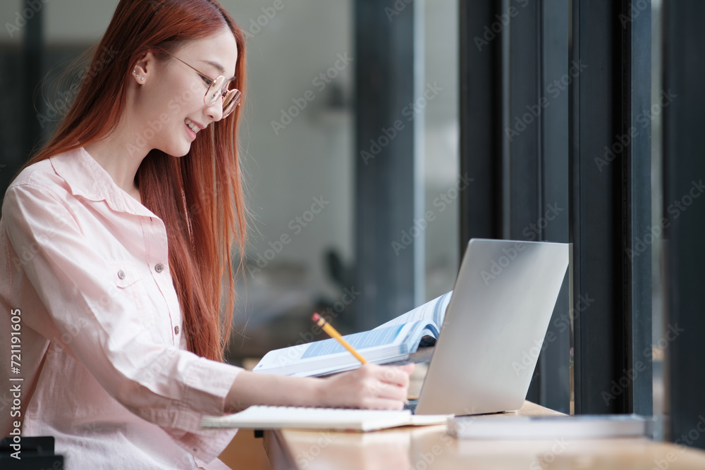 Young collage student using computer and mobile device studying online. Young collage student using computer and mobile device studying online.