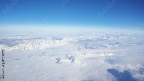 Mountain range and white clouds in blue sky at day