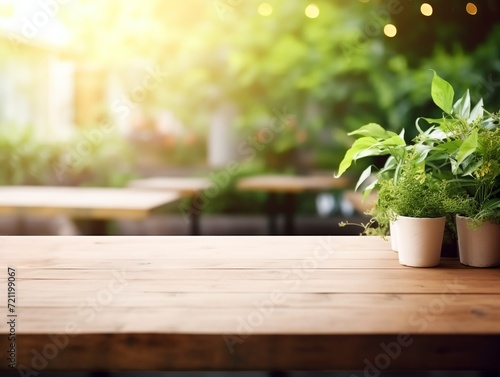 Modern cozy outdoor restaurant with green plants  blurred background with wooden table for product and text placement