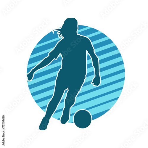 Silhouette of a female soccer player kicking a ball. Silhouette of a football player woman in action pose.