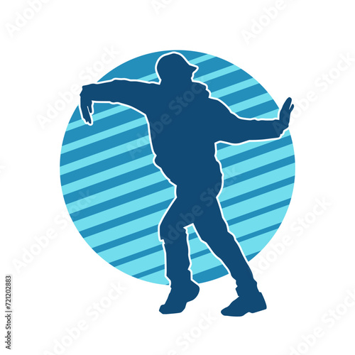 Silhouette of a slim man dancing pose. Silhouette of a male dancer in action pose.