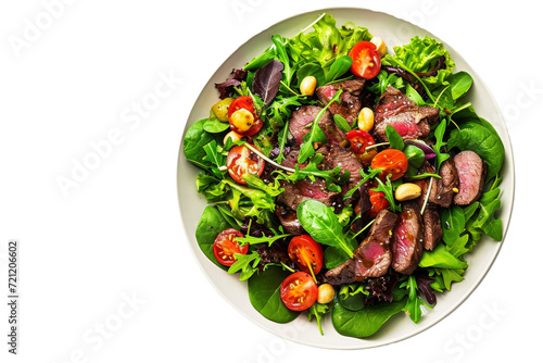 Top down view of a salad with ingredients, meat, bush tomatoes and macadamia nuts, on a white background. photo