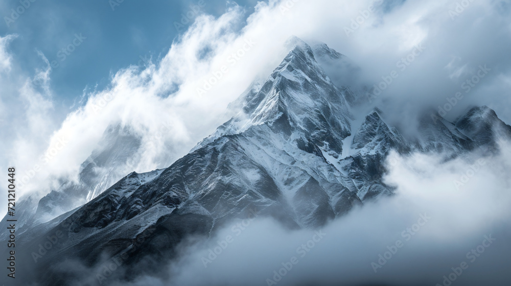 Clouds covering snow capped mountain