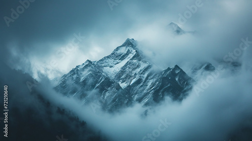 Clouds covering snow capped mountain