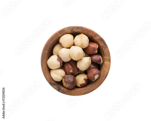 Top view of peeled hazelnuts in a wood bowl isolated on white background
