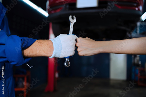 Auto mechanic with wrench in garage. Engine repair and maintenance Car repairs in the garage