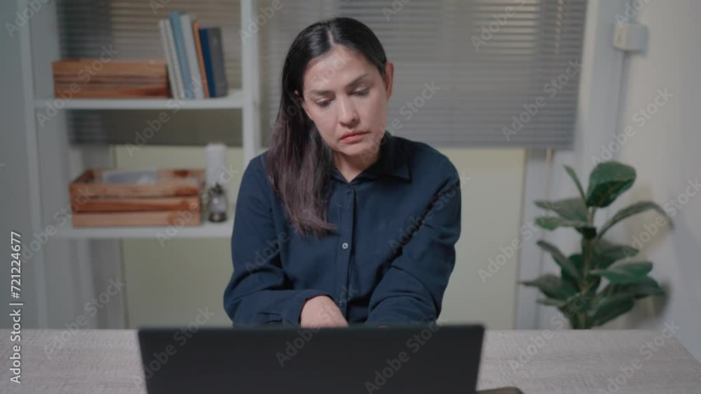 Sad woman having financial problems or cash gap in business, throwing away pay check, sitting at table with laptop in home office Sad woman having financial problems or cash gap in business, throwing away pay check, sitting at table with laptop in home office
