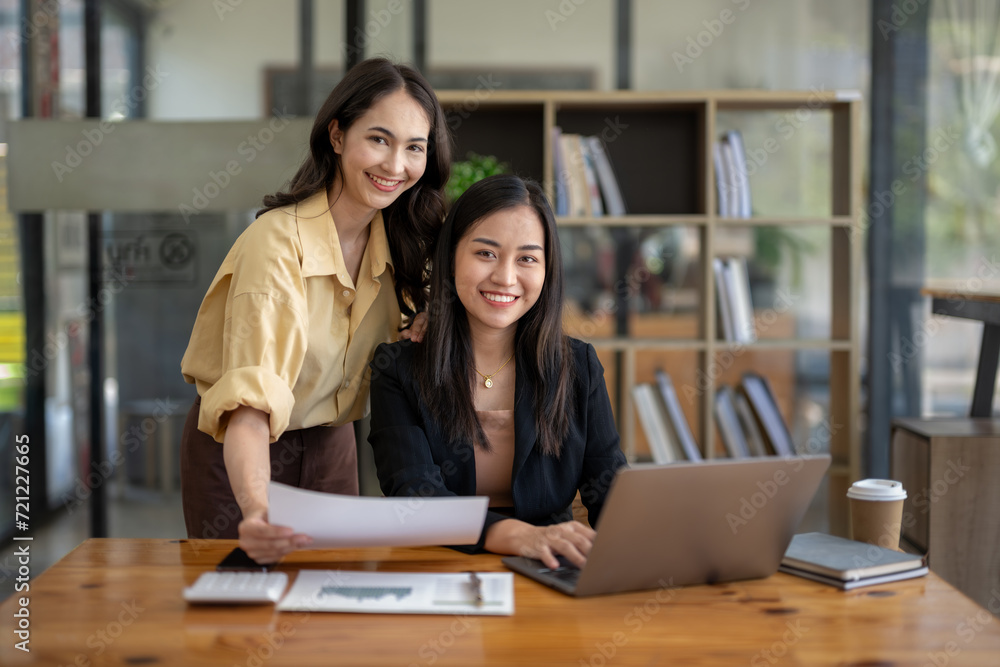 Business colleagues working using laptops, Collaborate on project plans, Consult marketing plans, Check document information Business colleagues working using laptops, Collaborate on project plans, Consult marketing plans, Check document information