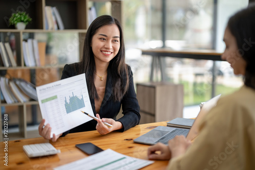 Two asian businesswoman accountants discuss financial management planning. Analysis of new startup project ideas