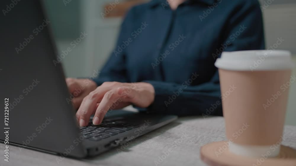 Close up of unrecognizable businesswoman sitting at workplace, drinking coffee and working on laptop.Thinking of a problem Solving business problems Creative remote working Close up of unrecognizable businesswoman sitting at workplace, drinking coffee and working on laptop.Thinking of a problem Solving business problems Creative remote working