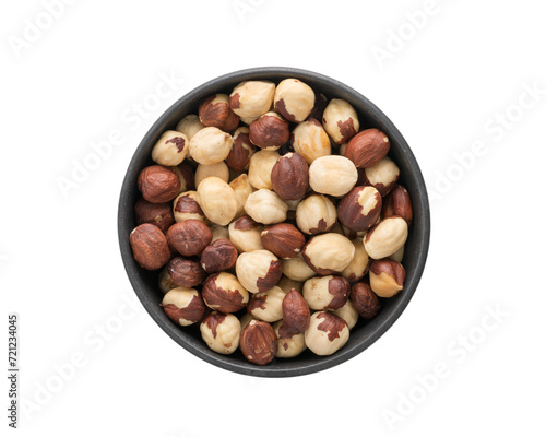Top view of peeled hazelnuts in a black bowl isolated on white background