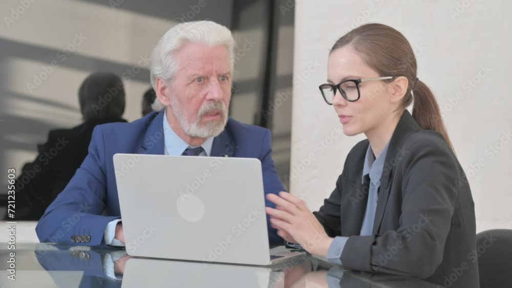 Businesswoman Talking with Senior Businessman in Office Businesswoman Talking with Senior Businessman in Office