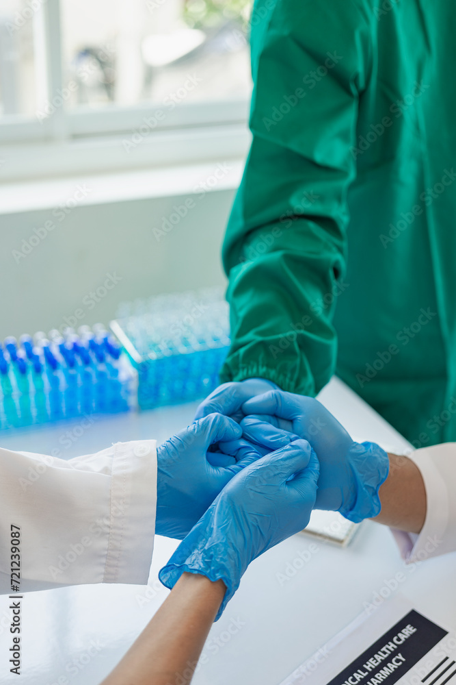 The medical team joins hands and works togetherGroup of scientists joining hands to create experimental works that meet their goals or the success of the trials that have been completed