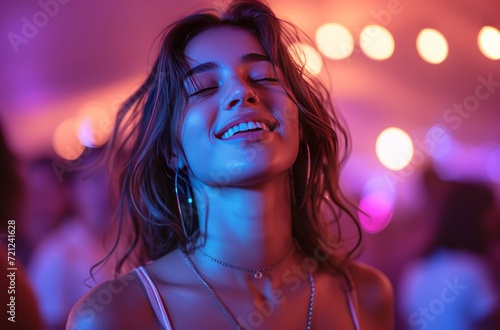 young woman dancing on a night at a club © olegganko