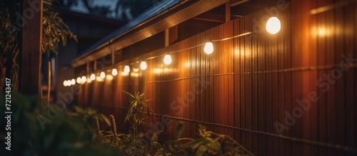Small solar powered LED lights on the front fence of the house with light at night