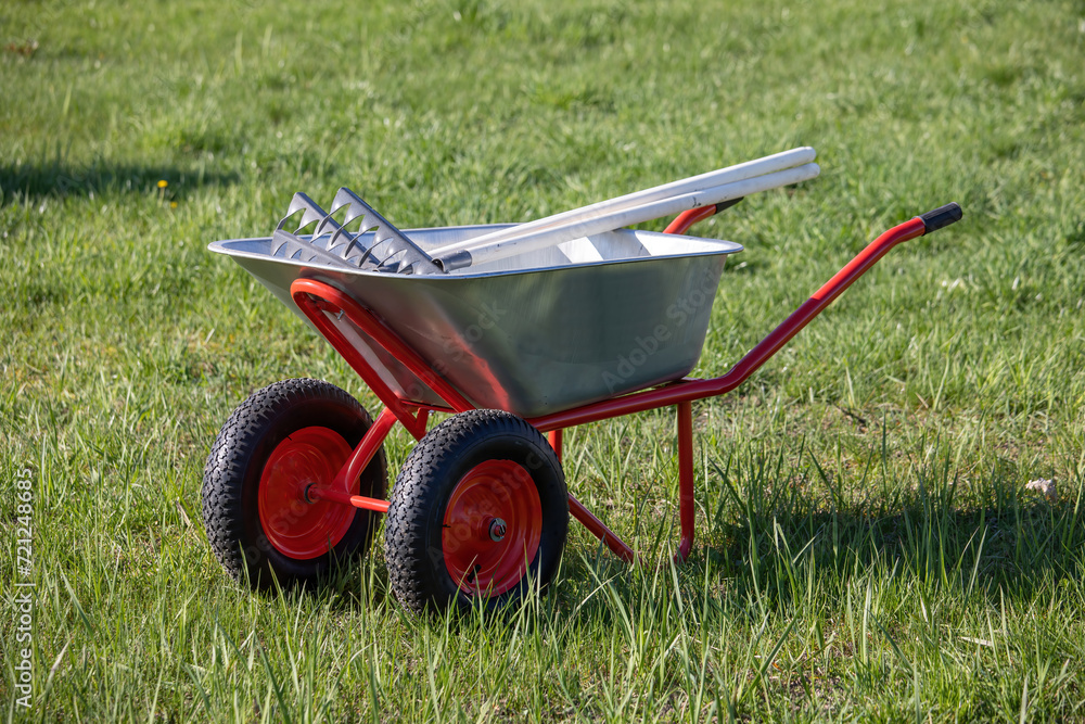 Obraz premium A hand cart on wheels with a garden tool.