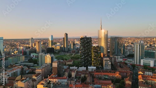 milan city porta nuova district aerial view drone pan at sunrise,urban cityscape skyline panoramic shot photo