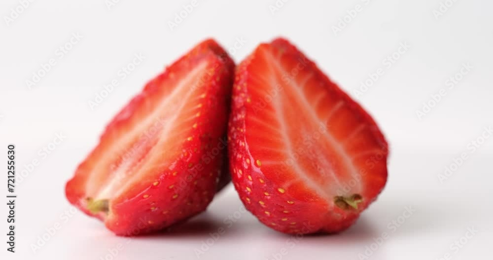 Juicy strawberries and strawberry halves closeup. Delicious summer berries isolated on white background Juicy strawberries and strawberry halves closeup. Delicious summer berries isolated on white background