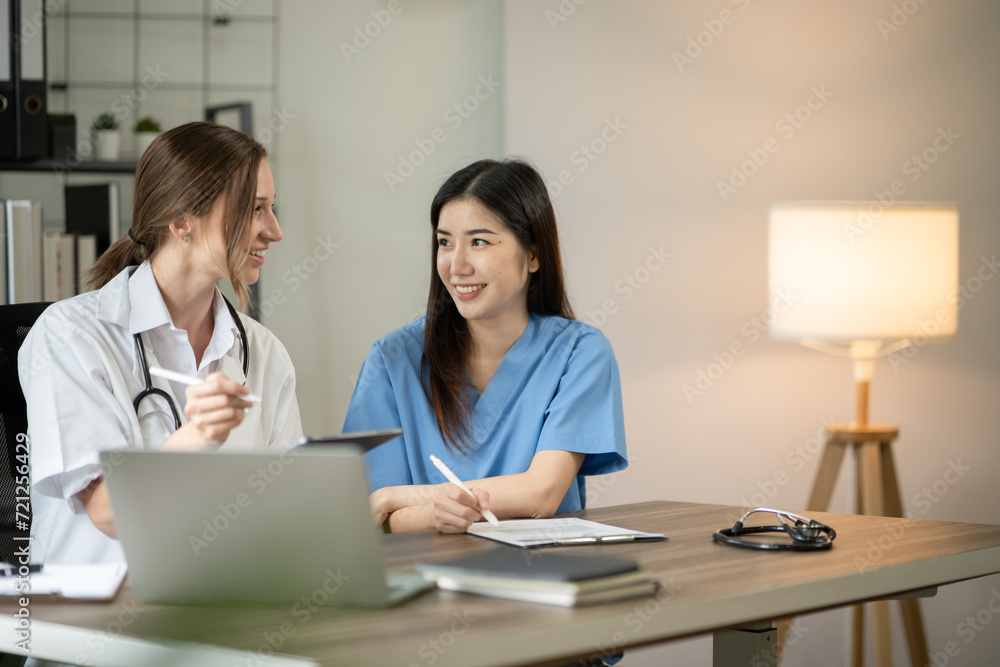 Female doctor sitting at work looking at the history of patients in the clinic or in the hospital Female doctor sitting at work looking at the history of patients in the clinic or in the hospital