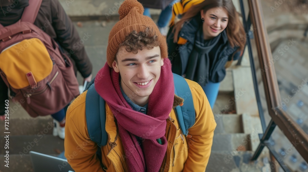 High angle of positive young students in warm clothes