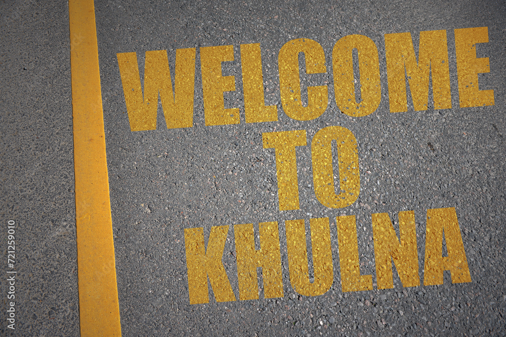 asphalt road with text welcome to Khulna near yellow line.