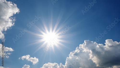 A bright sun shines through the clouds in the sky