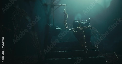 An evil altar at night with two dead bodies hanging on the gallows photo