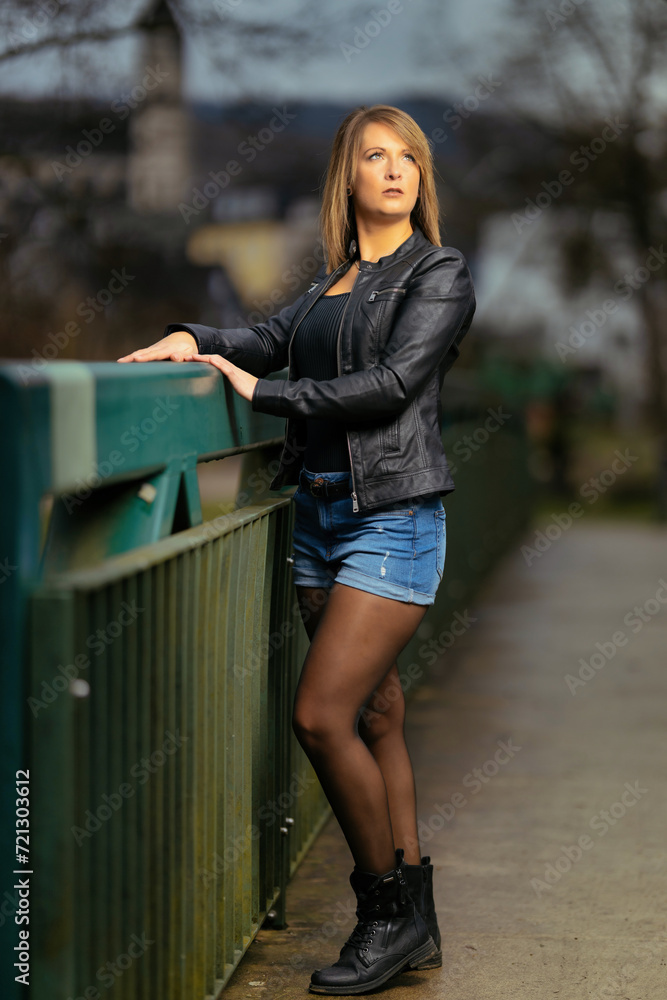 Young woman in her thirties photographed in portraits on a bridge with flash. Young woman in her thirties photographed in portraits on a bridge with flash.