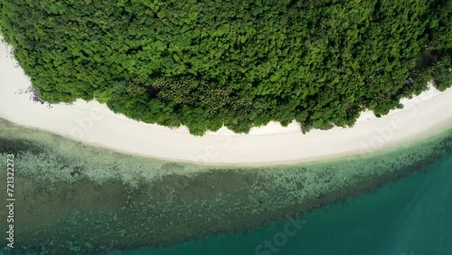 Aerial close up of bounty island coast showing the beautiful tropical beach forest and shallow ocean blue coloured water perfect place looks like paradise no people on the deserted coastal strip 4k photo