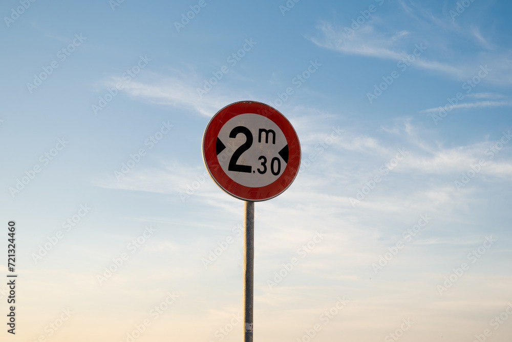 Width limit traffic sign, isolated sunset sky. Width limit traffic sign, isolated sunset sky.
