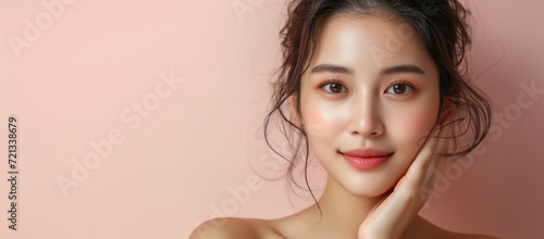 Natural beauty. Young woman with a glowing complexion and a natural makeup look, showcasing flawless skin and a gentle touch to her face