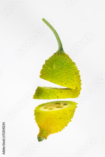 Spiny gourd or spine gourd also known as bristly balsma pear, prickly carolaho isolated on white background photo