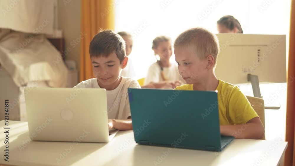 group of children study at home via laptops. business concept of modern training and development. little kids are educated through the computer. two boys with laptops lifestyle in the foreground group of children study at home via laptops. business concept of modern training and development. little kids are educated through the computer. two boys with laptops lifestyle in the foreground