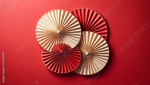 Elegant Geometric Composition with Three Traditional Paper Fans on Red Background