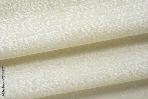 close-up of folded ivory crepe paper texture