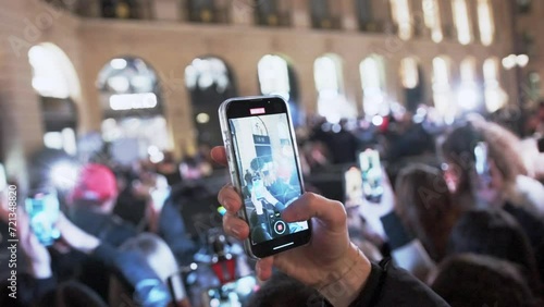 Hands filming video, photo on Fashion week in Paris. Close up phones photo