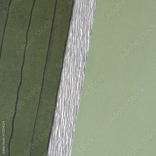 striped dark green paper, silver crepe paper stripe, and solid green paper background