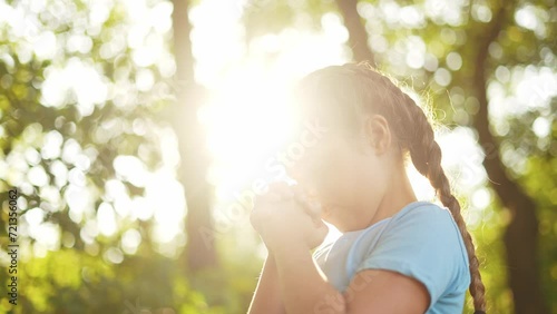 child pray. young gratitude a god religion concept. little girl in nature outdoors praying dreams of happiness lifestyle to god. praise worship freedom concept. kid praying in the forest photo