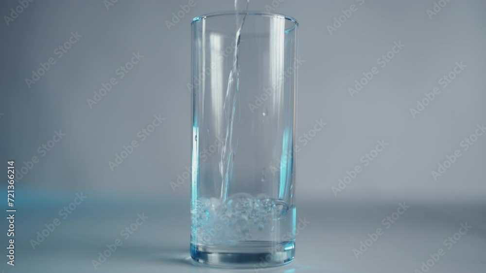 Clear water pouring into a clean glass, good quality, importance of hydration Clear water pouring into a clean glass, good quality, importance of hydration