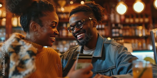 Close-up as a smiling couple effortlessly uses an artificial intelligence-enhanced bank credit or debit card, symbolizing the seamless integration of advanced technology. © Nattadesh
