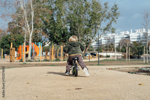 Little toddler boy riding on his bicycle