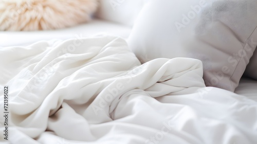 synthetic blanket and pillow on a white sheet. Selective focus