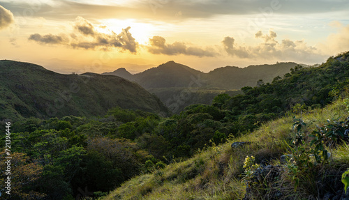 Fototapeta Naklejka Na Ścianę i Meble -  Beautiful sunset on green hill of El Valle de Anton in panama with mountains and jungle in background